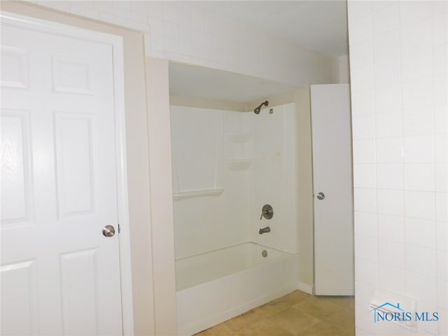 bathroom with bathing tub / shower combination