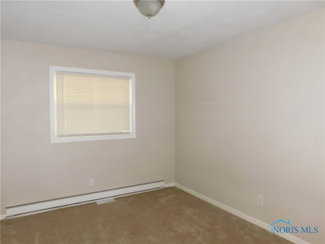 spare room with a baseboard heating unit and carpet flooring