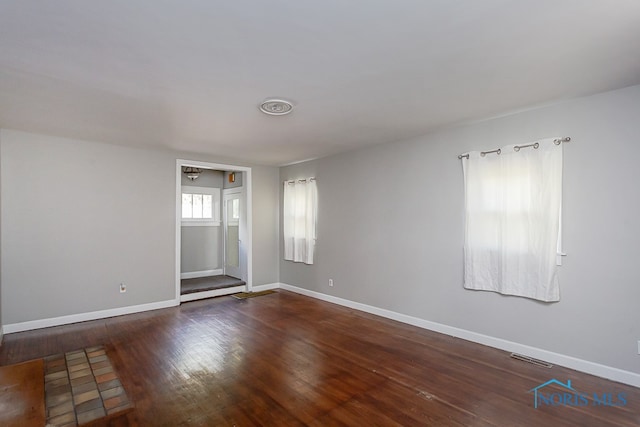 empty room featuring dark wood-type flooring