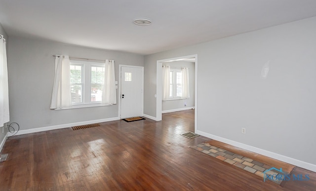 entryway with dark hardwood / wood-style flooring