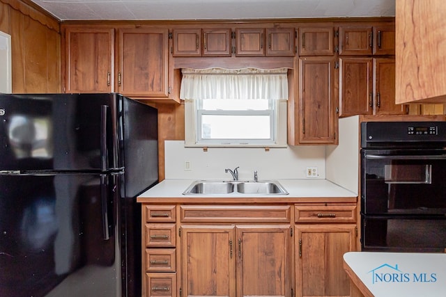 kitchen featuring black appliances and sink