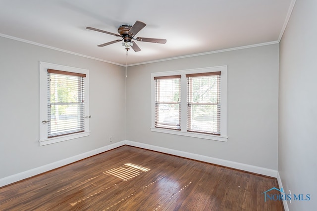 empty room with ceiling fan, ornamental molding, and dark hardwood / wood-style floors