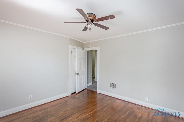 empty room featuring crown molding, dark hardwood / wood-style floors, and ceiling fan