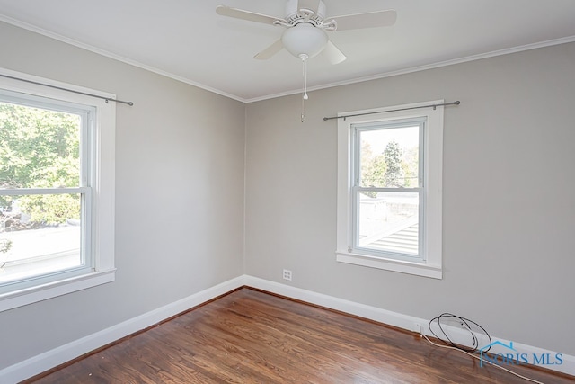 unfurnished room with ornamental molding, ceiling fan, and dark hardwood / wood-style flooring