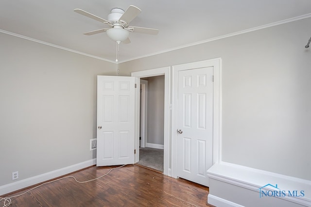 unfurnished bedroom featuring ceiling fan, crown molding, and dark hardwood / wood-style flooring