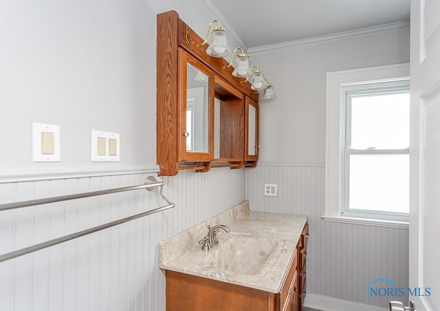 bathroom featuring vanity, crown molding, and a wealth of natural light