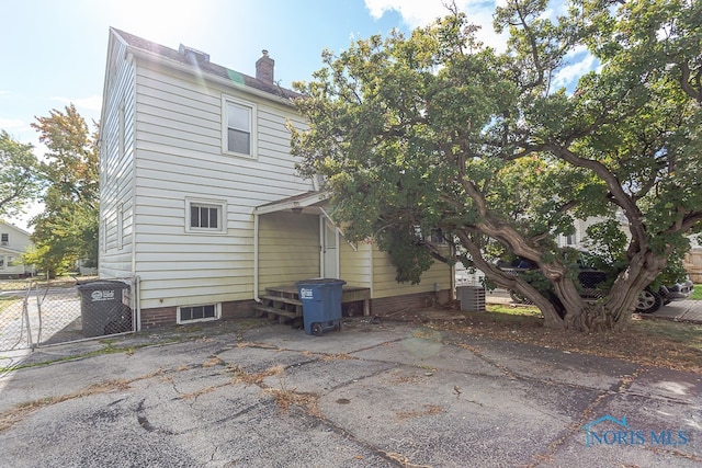 rear view of house with central AC