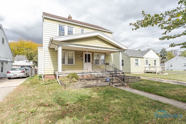 view of front facade featuring a front yard and a porch