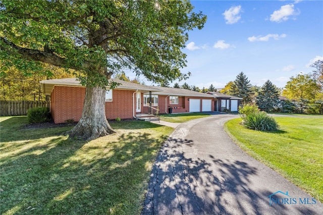 ranch-style home featuring a front lawn and a garage