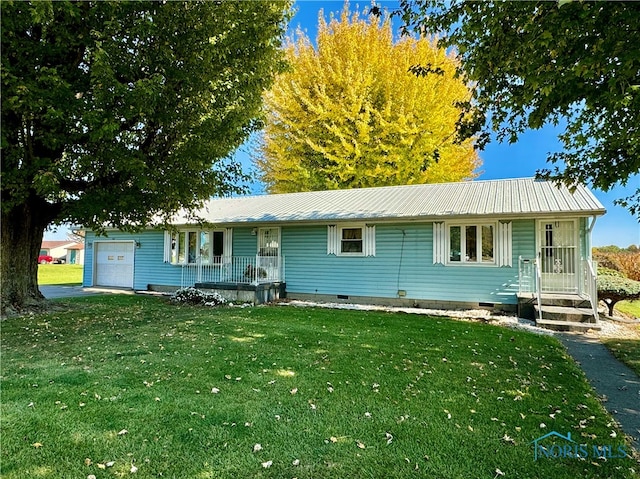 single story home featuring a front yard, covered porch, and a garage