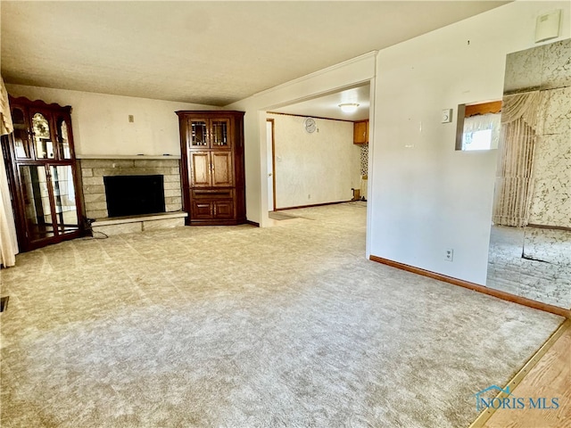 unfurnished living room with carpet, vaulted ceiling, and a stone fireplace