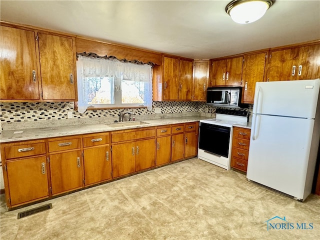 kitchen with light carpet, sink, backsplash, and white appliances