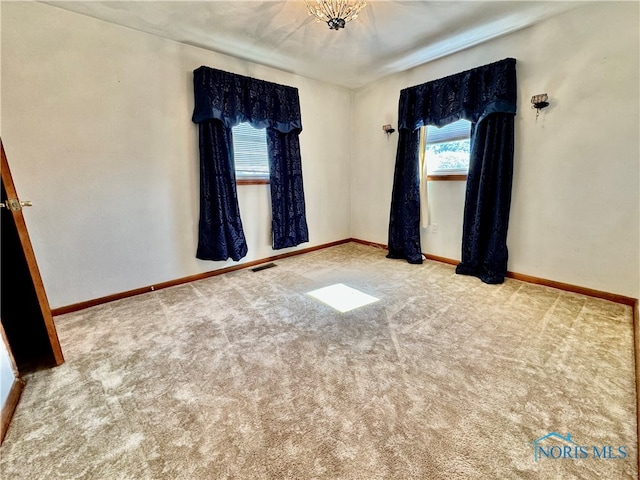 carpeted empty room featuring plenty of natural light