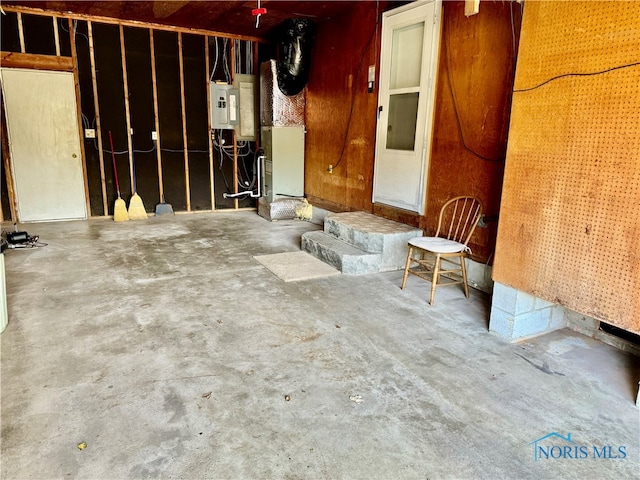 garage with heating unit and electric panel