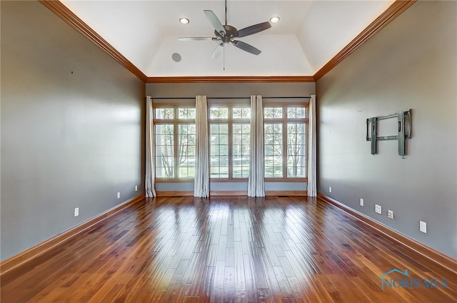 empty room featuring crown molding, dark hardwood / wood-style floors, and vaulted ceiling