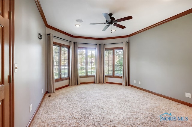 carpeted empty room with crown molding and ceiling fan