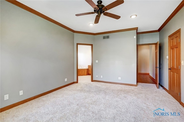 unfurnished bedroom with crown molding, light carpet, ensuite bathroom, and ceiling fan