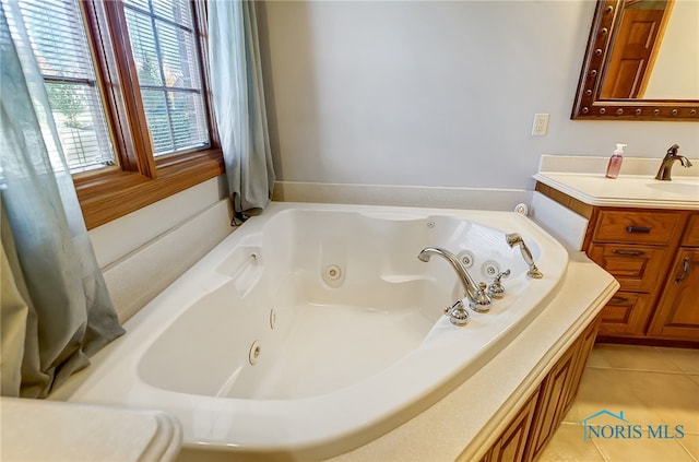 bathroom with vanity, a bathtub, and tile patterned flooring