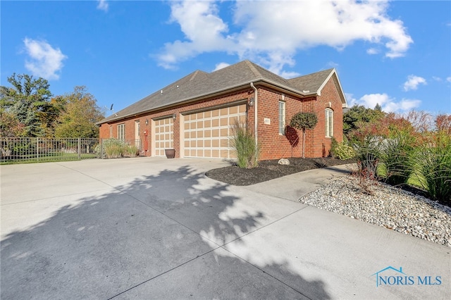 view of side of home featuring a garage