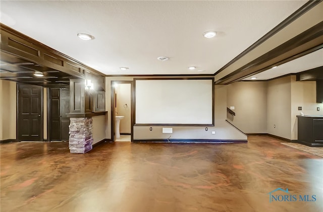 cinema room with crown molding and a fireplace