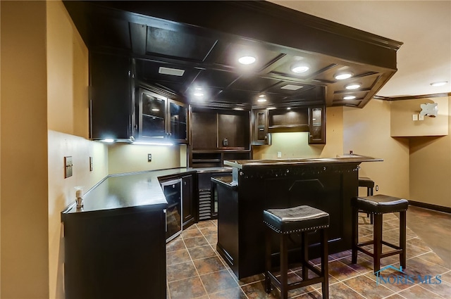 bar featuring ornamental molding, coffered ceiling, dark tile patterned flooring, and beverage cooler