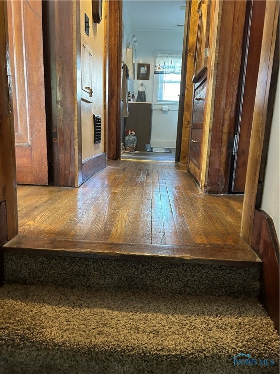 hall with wood-type flooring