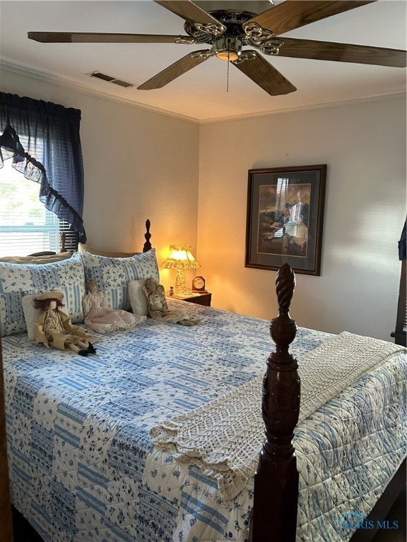 bedroom featuring ornamental molding and ceiling fan