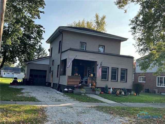 view of front of house with covered porch, a front lawn, and a garage