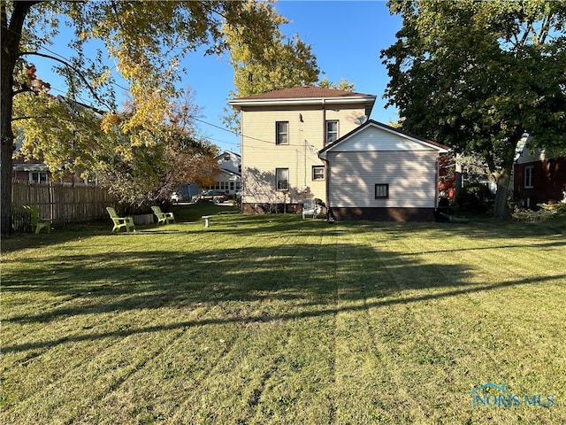 rear view of property with a lawn