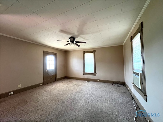 spare room with ceiling fan, crown molding, and carpet floors