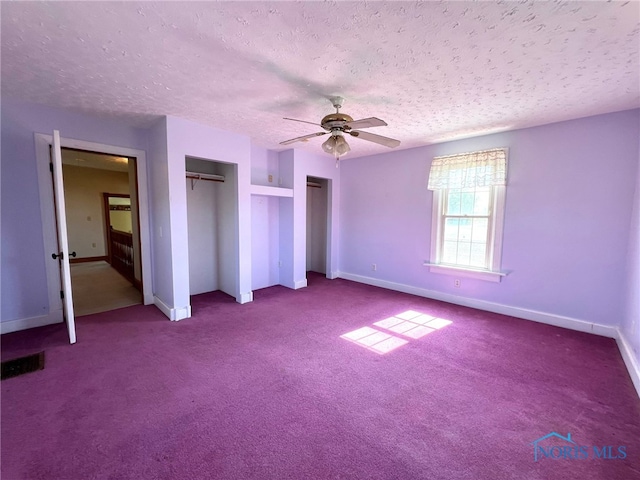 unfurnished bedroom featuring a textured ceiling, carpet flooring, and ceiling fan