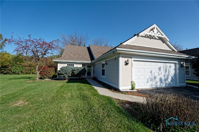 view of side of home featuring a garage and a lawn