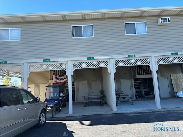 rear view of property with a carport