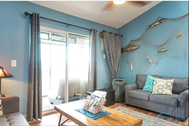 living room featuring hardwood / wood-style flooring and ceiling fan