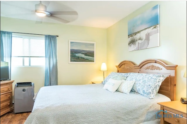 bedroom with hardwood / wood-style flooring and ceiling fan