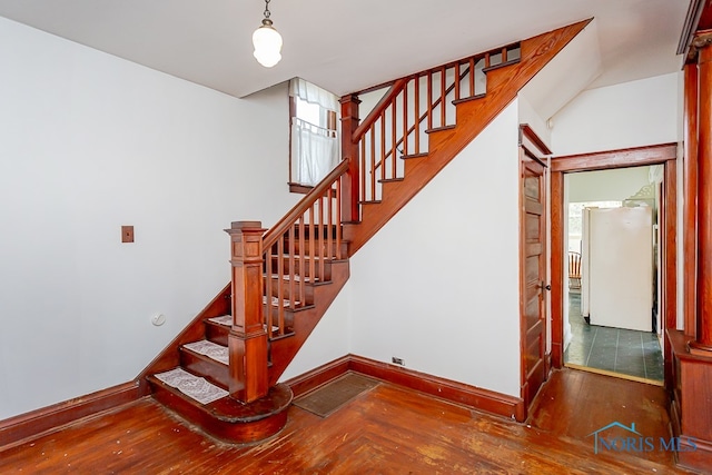 stairs with wood-type flooring