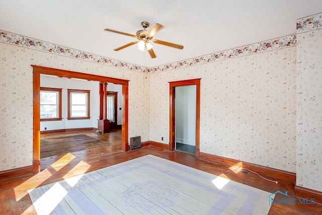 unfurnished room featuring ceiling fan and dark hardwood / wood-style flooring