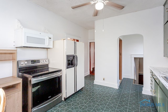 kitchen with white appliances, ceiling fan, and a textured ceiling