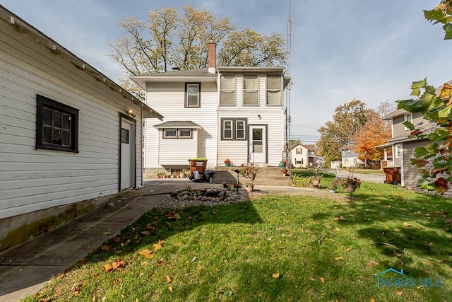 rear view of house featuring a yard and a patio