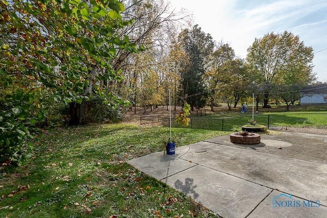 view of yard with a patio area and an outdoor fire pit