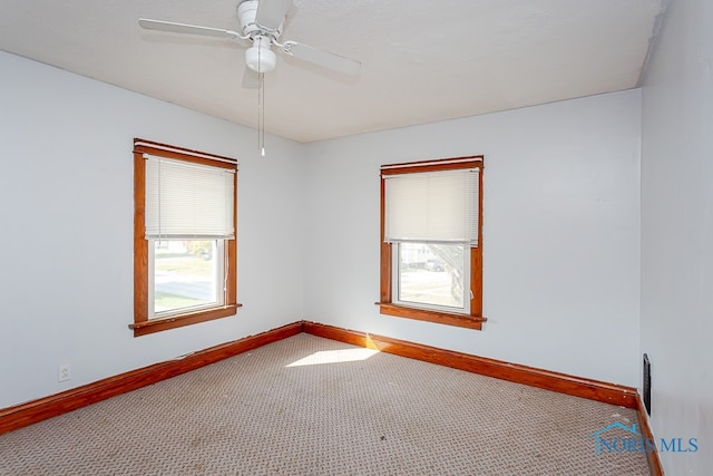 carpeted empty room with ceiling fan