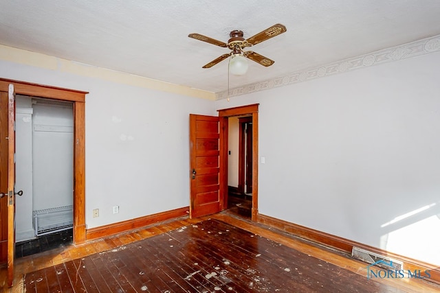 unfurnished bedroom featuring a closet, ceiling fan, a textured ceiling, and dark hardwood / wood-style floors