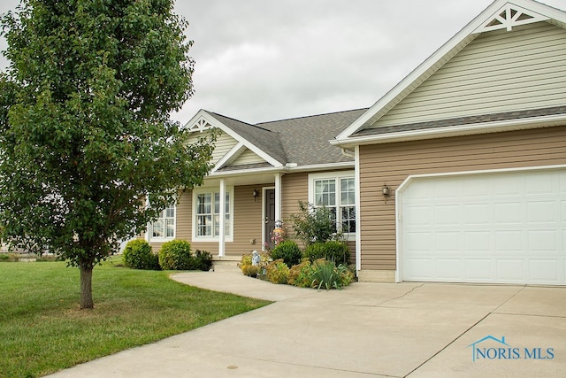 view of front of home with a front lawn and a garage