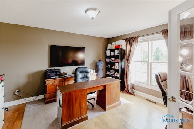 office featuring light hardwood / wood-style floors and plenty of natural light