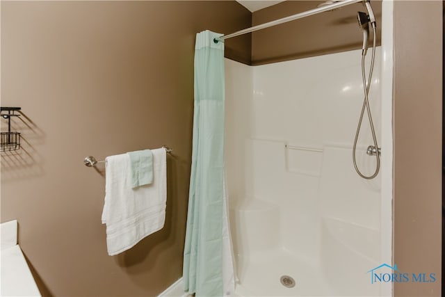 bathroom with a shower with shower curtain