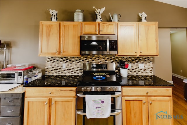 kitchen with appliances with stainless steel finishes, wood-type flooring, backsplash, and light brown cabinets