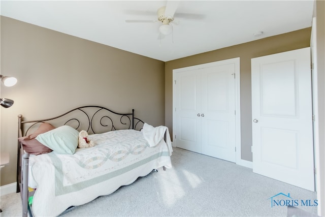 carpeted bedroom with a closet and ceiling fan