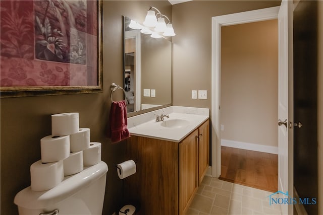 bathroom featuring vanity, hardwood / wood-style floors, and toilet