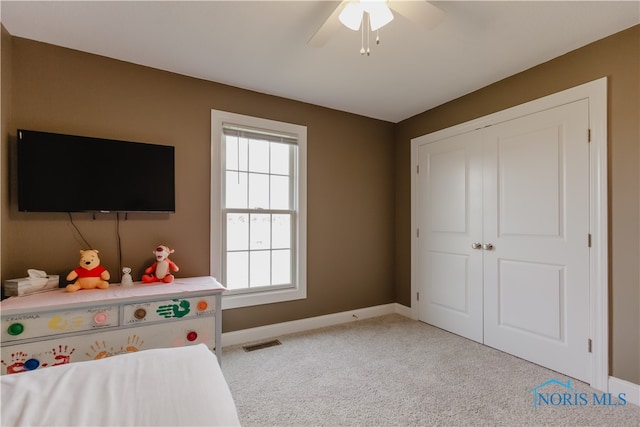 interior space featuring ceiling fan and light colored carpet