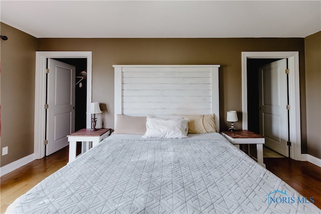 bedroom with dark wood-type flooring